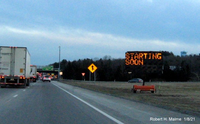 Image of VMS sign along right shoulder approaching the Harrison Blvd. exit alerting traffic to the exit
                                      renumbering project on MA 24 South in Avon, January 2021