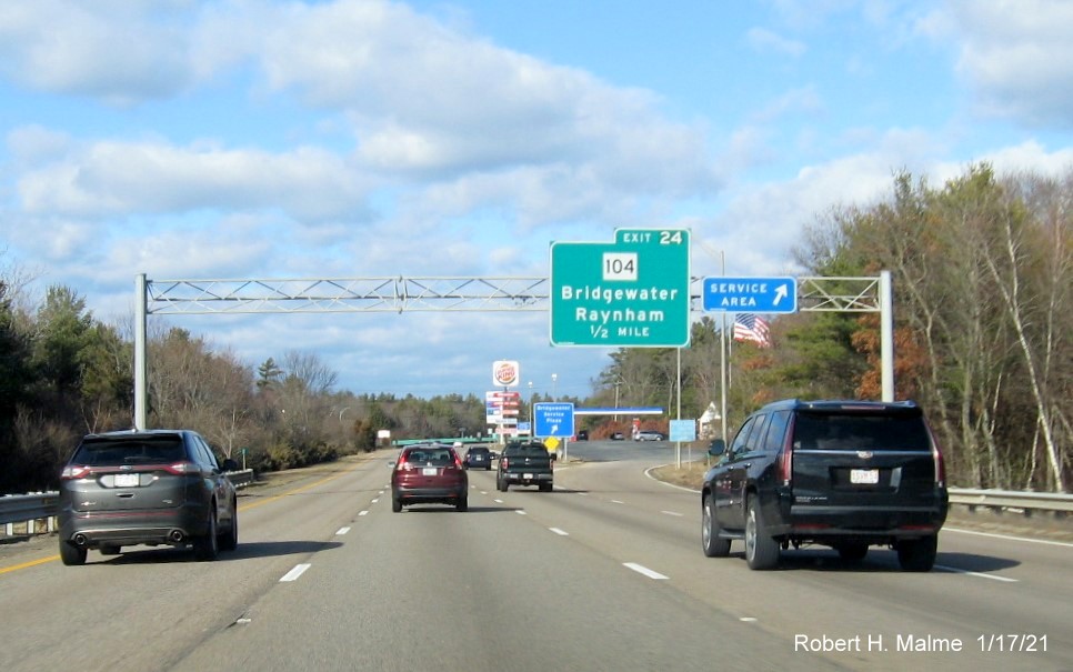 Image of 1/2 Mile advance overhead sign for MA 104 exit with new milepost based exit number on MA 24 North in Bridgewater, January 2021