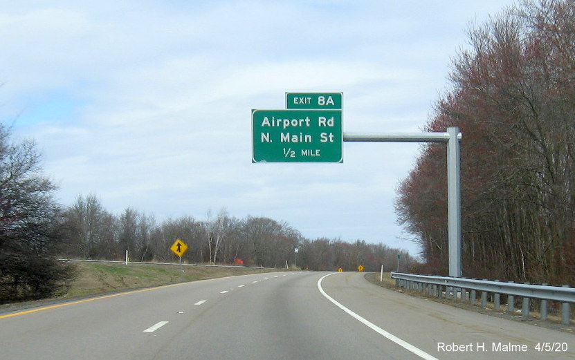 Image of recently placed 1/2 mile advance overhead sign for the Airport Road/North Main Street exit on MA 24 North in Fall River, taken in April 2020