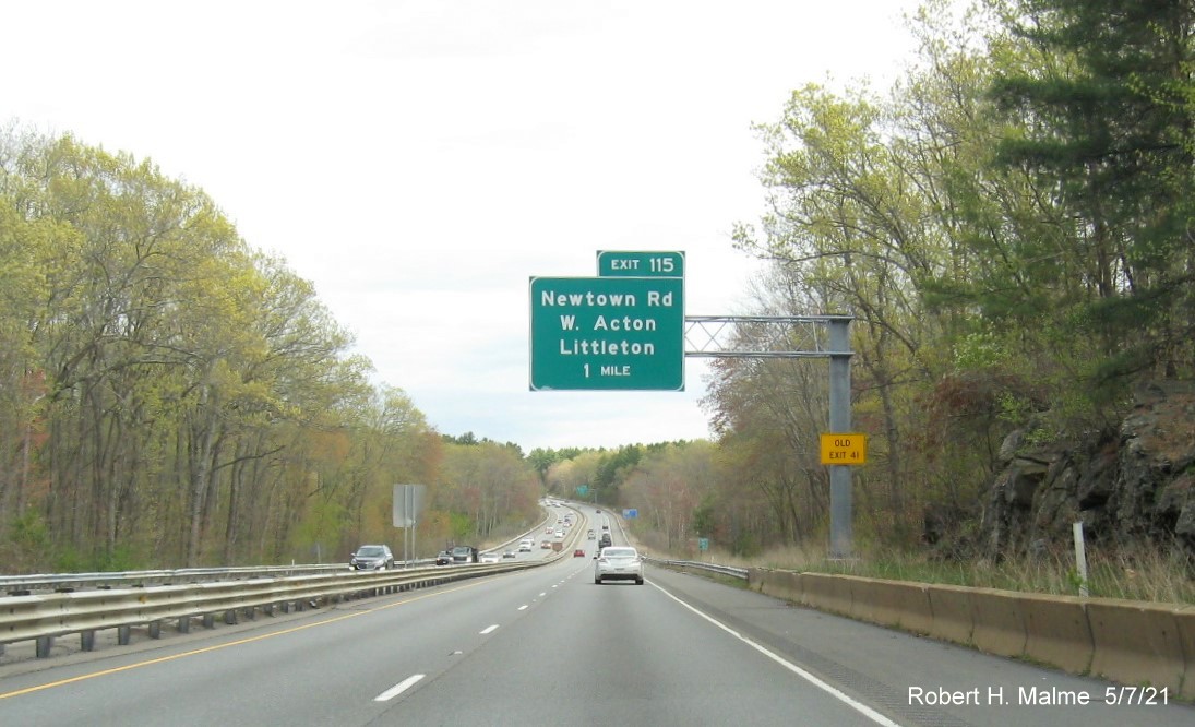 Image of 1 Mile advance overhead sign for Newtown Road exit with new milepost based exit number and yellow 
                                       Old Exit 41 advisory sign on support on MA 2 East in Acton, May 2021