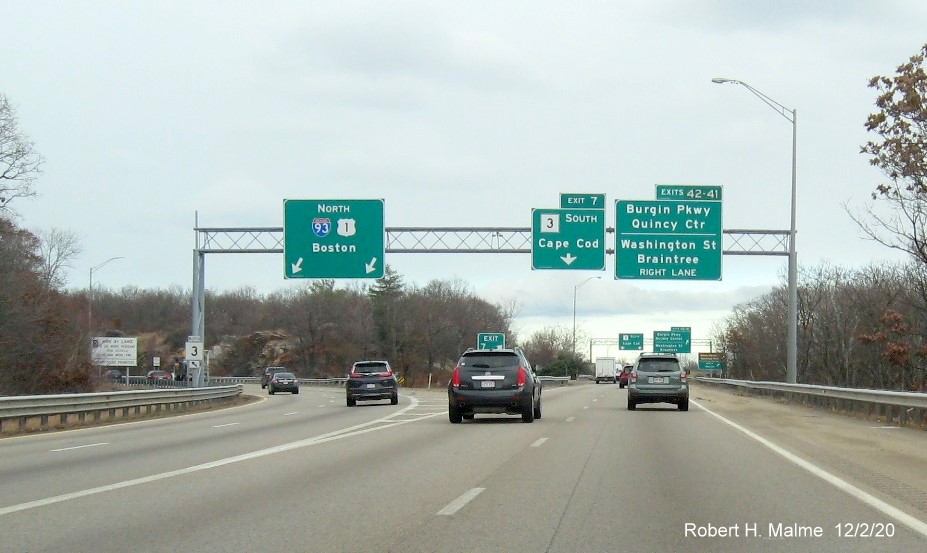 Image of overhead signs with 1/4 mile advance for Burgin Parkway/Washington Street exits with new milepost 
                                      exit numbers at MA 3 South exit ramp from I-93/US 1 in Braintree, December 2020