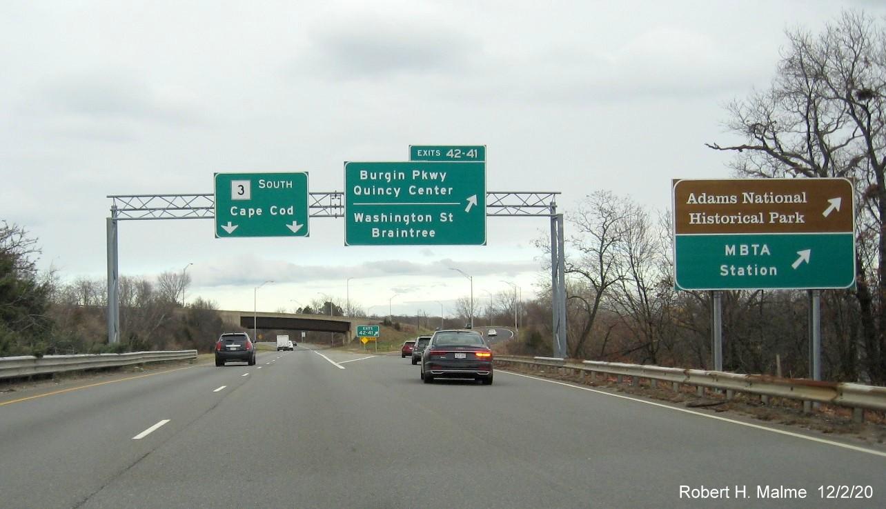 Image of overhead signs at ramp to Burgin Parkway/Washington Street exits with new milepost exit numbers on ramp from
                                      I-93/US 1 North to MA 3 South in Braintree, December 2020