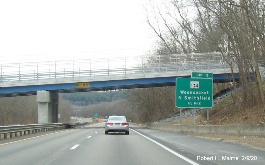 Image of recently placed 1/2 mile advance sign with new milepost based number for RI 104 exit on RI 146 South in North Smithfield