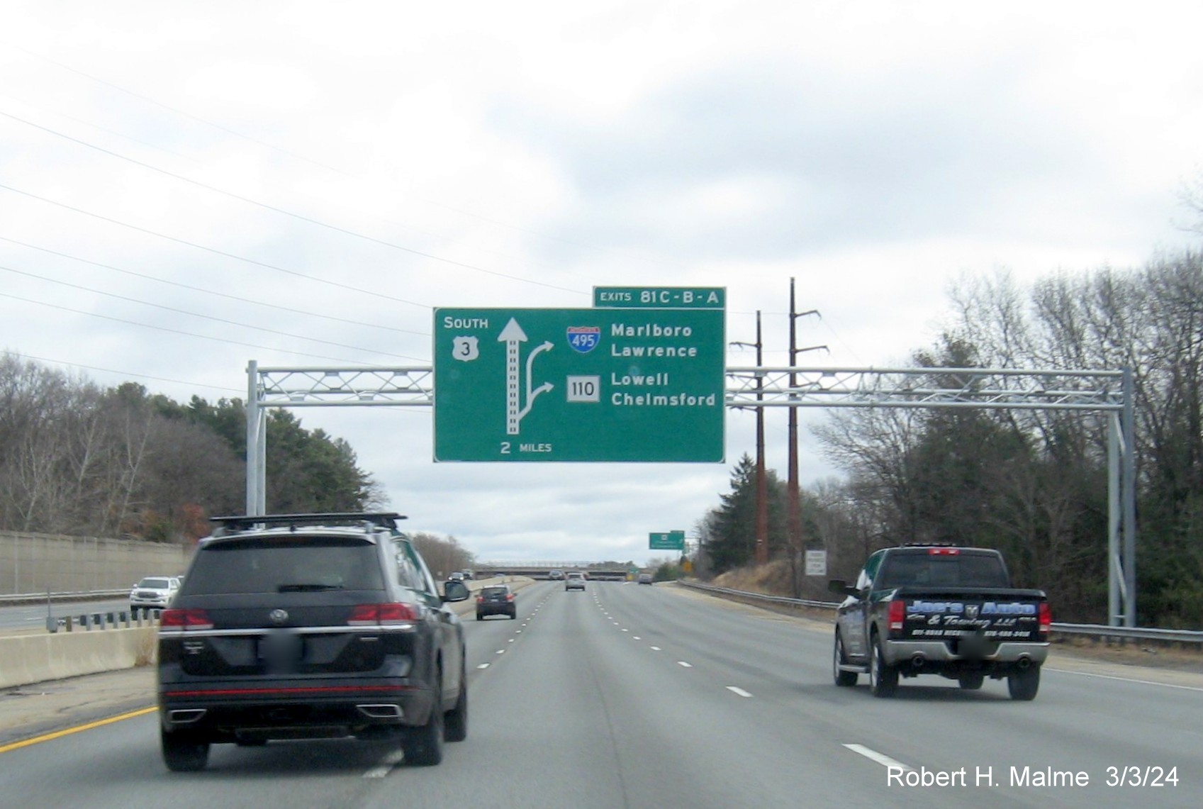 Image of newly placed 2 Miles advance overhead diagrammatic sign for I-495/MA 110 exits on US 3 South in Chelmsford, March 2024