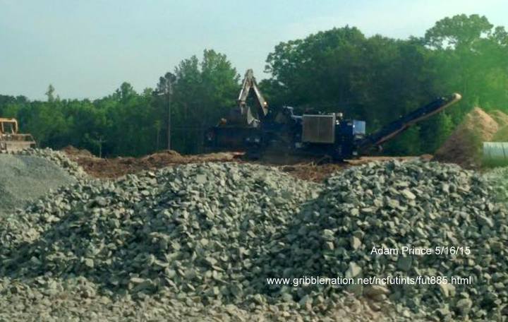 Image of broken rock being placed in East End Connector project area in Durham, photo by Adam Prince