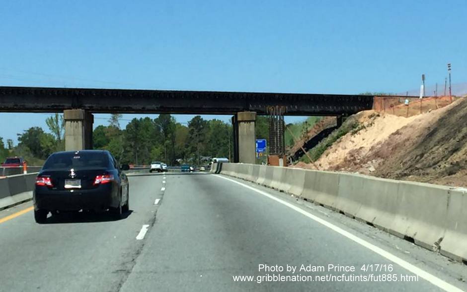 Image of future railroad bridge being constructed in front of existing bridge over US 70 as part of East End Connector project, by Adam Prince