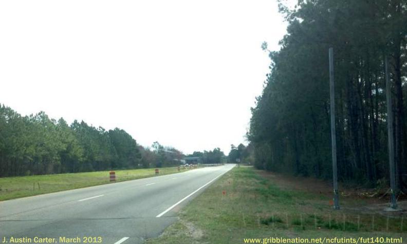 Photo of posts for future I-140 exit sign, 1 mile from interchange with US 74/
76 west of Wilmington, by J. Austin Carter, March 2013