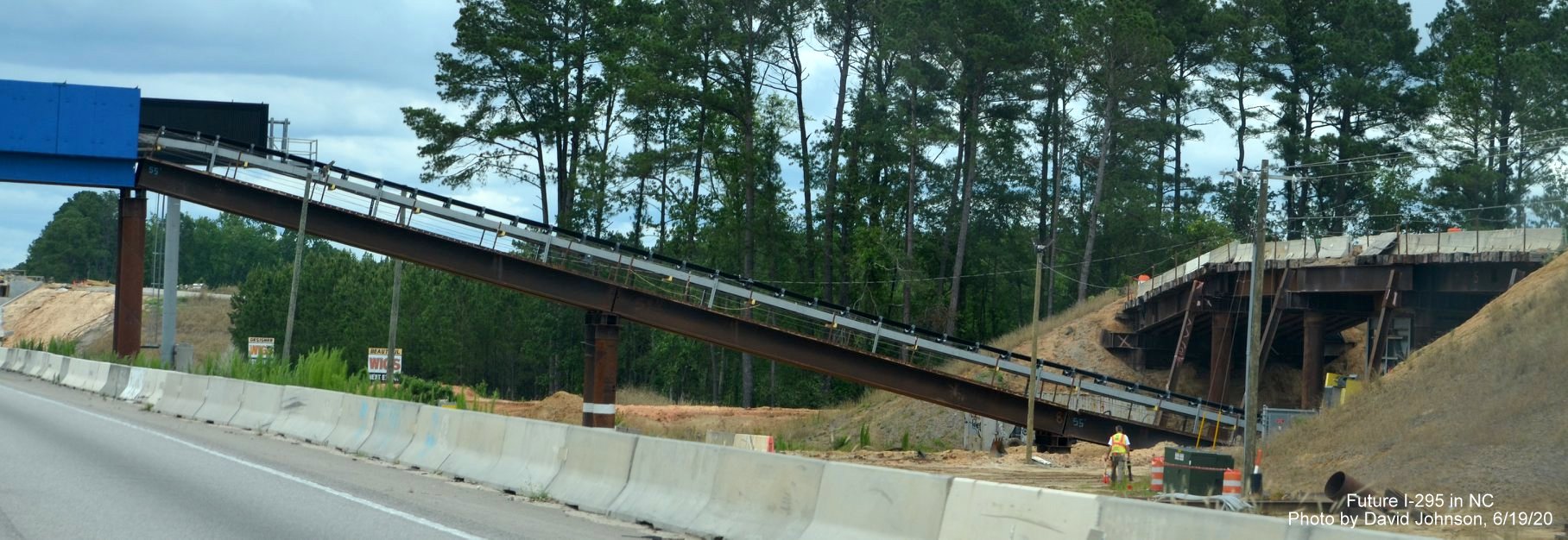View of conveyor belt for dirt being carried across I-95 from besides northbound lanes at site of 
        future I-295 interchange near Hope Mills, by David Johnson June 2020