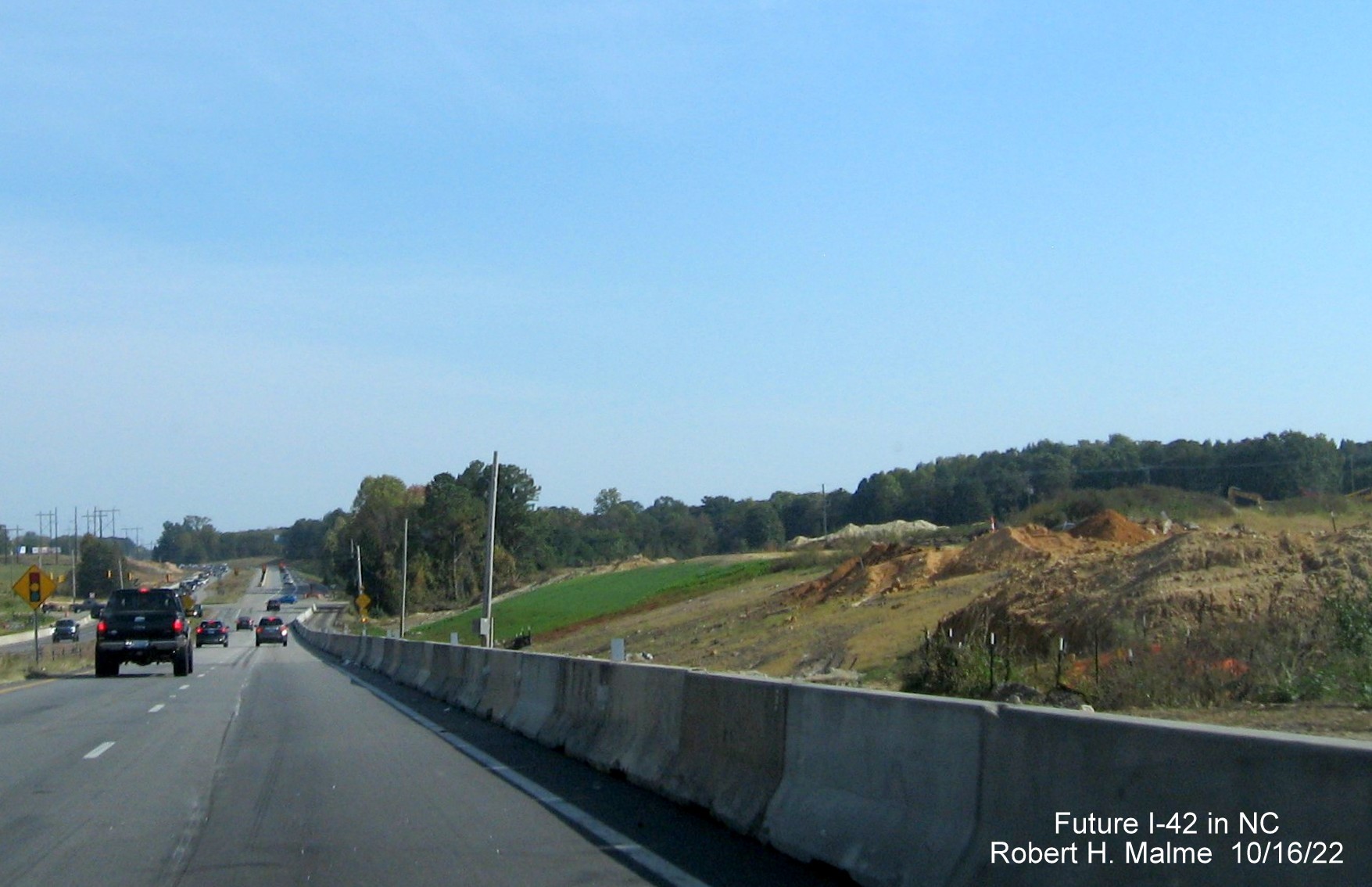 Image of construction barrier separating US 70 East traffic from construction of future I-42 East lanes approaching Swift Road in Wilson Mills, October 2022