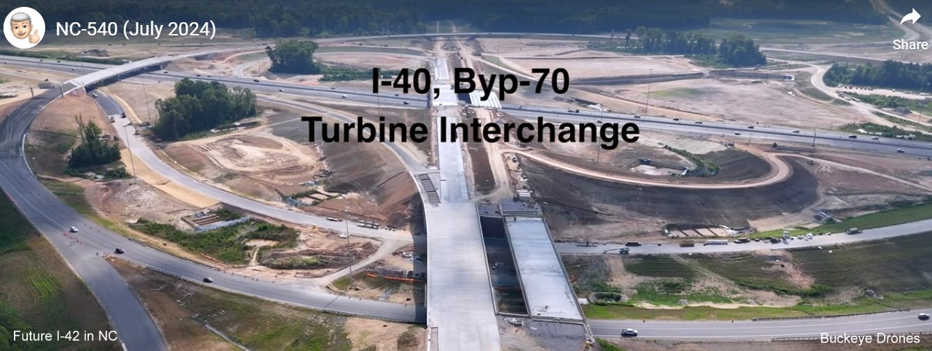 Screen grab image from Buckeye Drones video of the Turbine interchange with I-40 and US 70 shields
on Future NC 540 East at NC 50 interchange near completion, July 2024