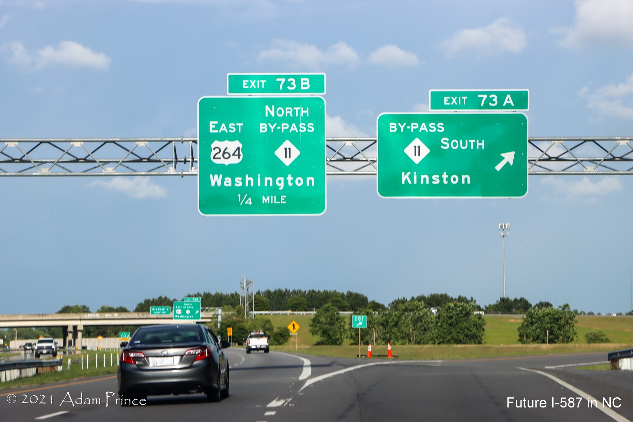 Image of overhead ramp sign for US 264 East/NC 11 Greenville Bypass exit on US 264 
	East (Future I-587 South) in Greenville, photo by Adam Prince, June 2021