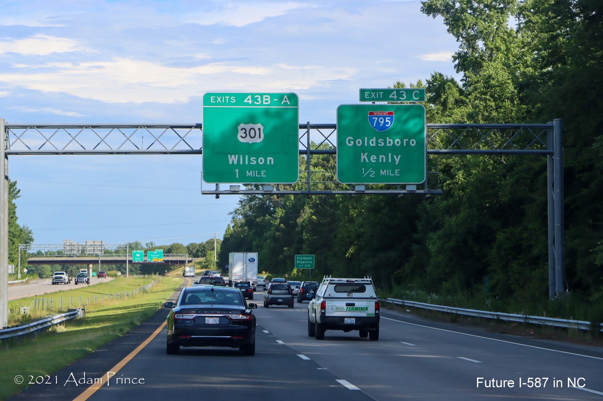 Overhead advance signs for US 301 and I-795 South exits on US 264 (Future I-587) 
	East in Wilson, photo by Adam Prince, June 2021