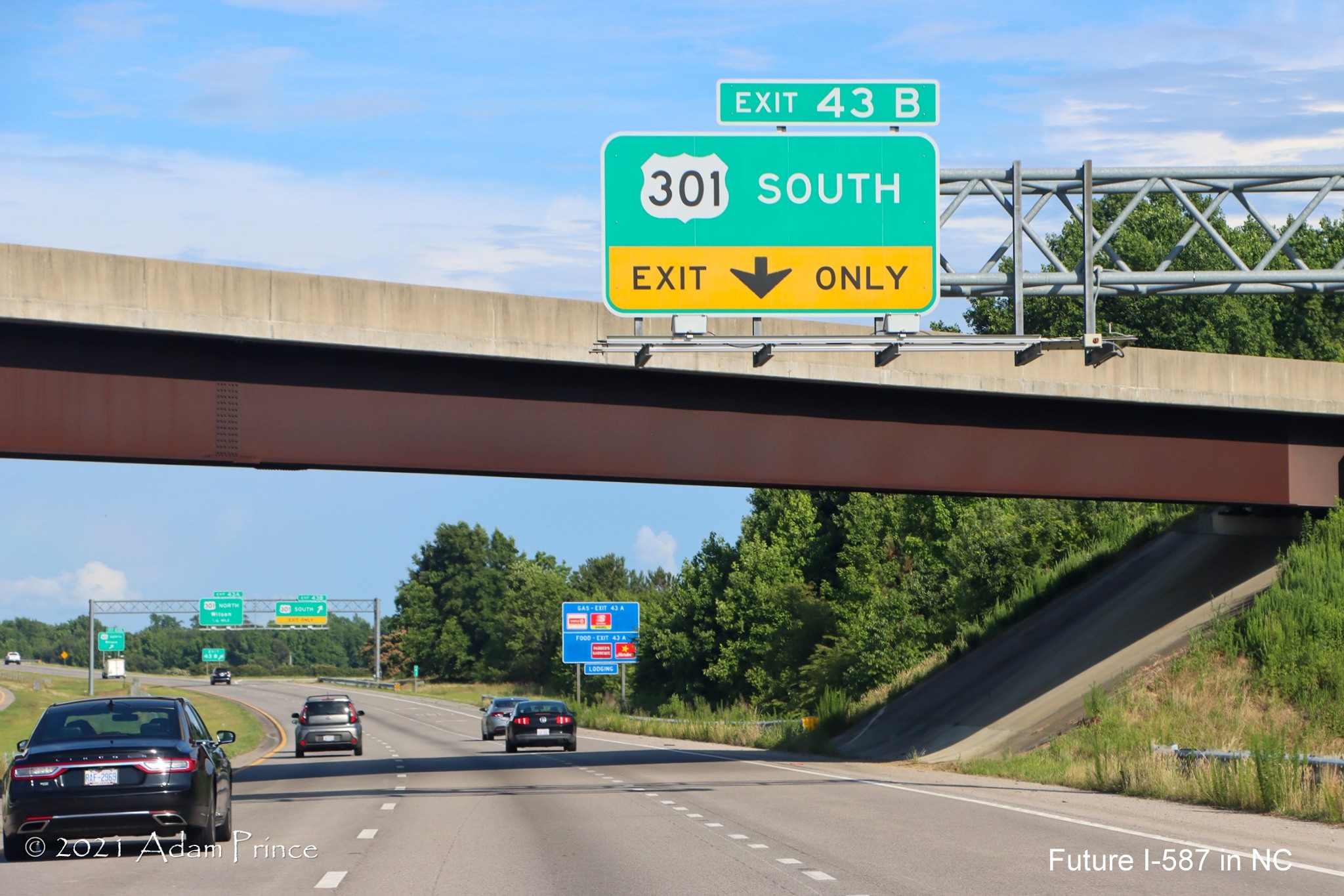 Overhead 1/4 mile advance signage for US 301 South exit US 264 West (Future I-587 
	North) in Wilson, photo by Adam Prince, June 2021