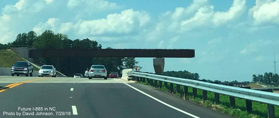 Image of US 70 traffic heading under flyover ramp for future US 70 West/I-885 South East End Connector interchange in Durham, by David Johnson