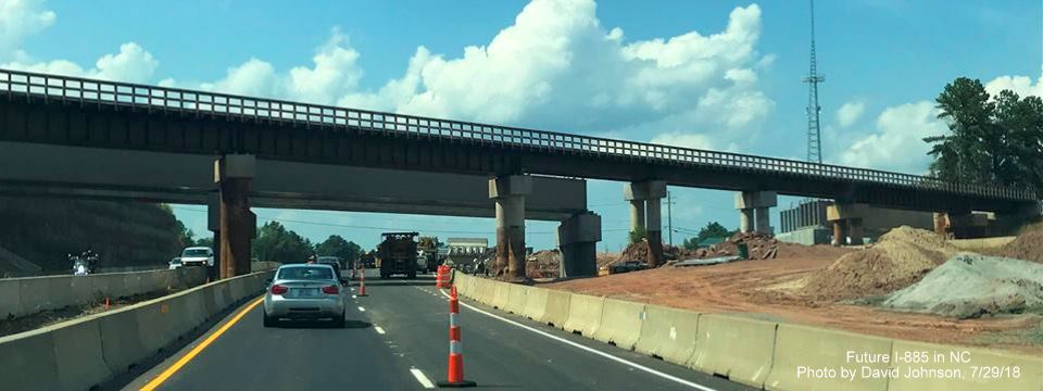 Image of US 70 West approaching temporary and future railroad bridge over Future I-885 South lanes in East End Connector Project work zone in Durham, by David Johnsonc