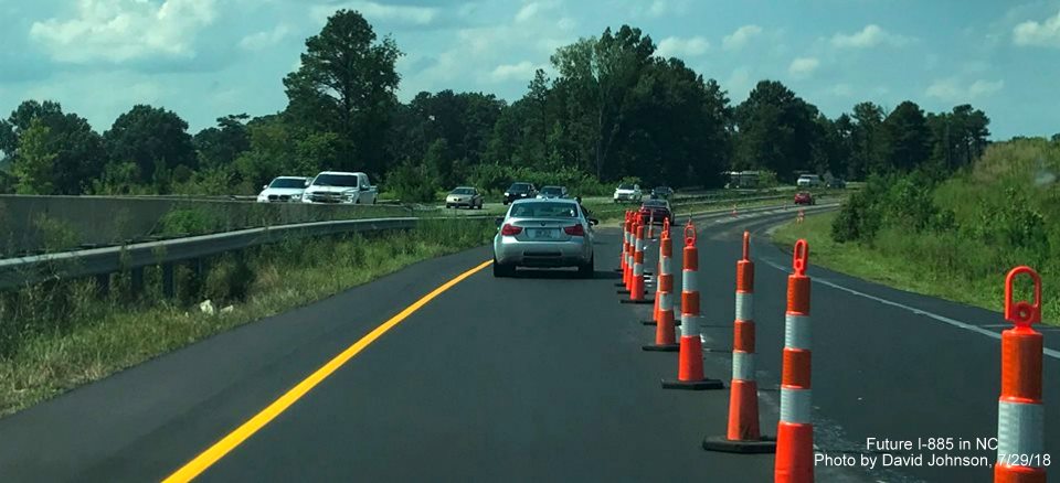 Image of traffic using newly repaved lanes of US 70 West near NC 98 interchange in East End Connector Project work zone, by David Johnson