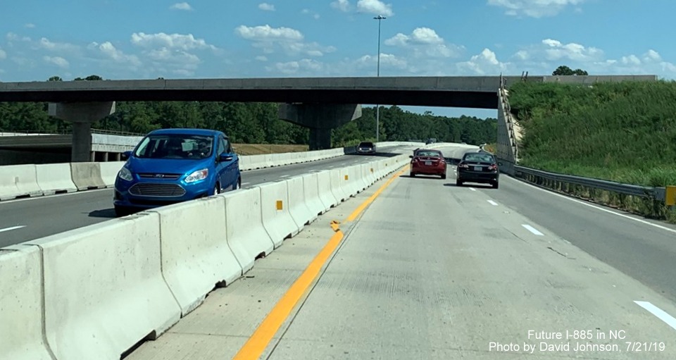 Image of NC 147 South traffic about to pass under completed flyover ramp to Future I-885 roadway in Durham, by David Johnson