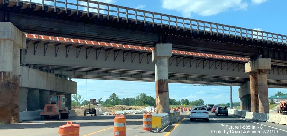 Image of new railroad bridge being constructed across US 70 (Future I-885) lanes in East End Connector Project work zone in Durham, by David Johnson