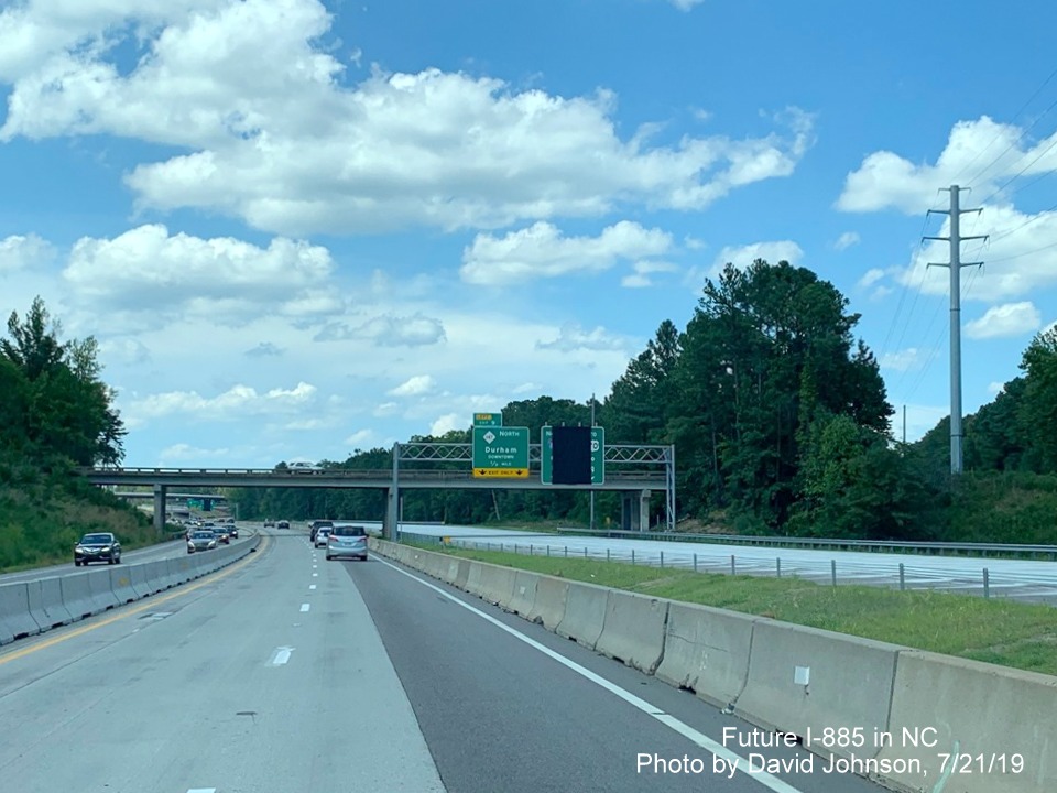 Image of traffic on temporary NC 147 lanes paralleling future lanes on right, close to completion, by David Johnson