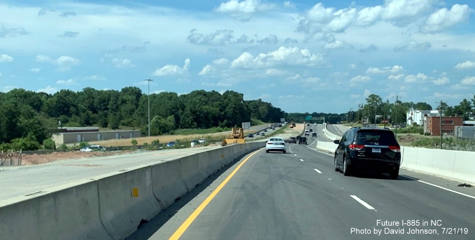Image of traffic on new US 70 West (Future I-885 North) lanes at NC 98/Bus. US 70 exit in East End Connector Project work zone in Durham, by David Johnson