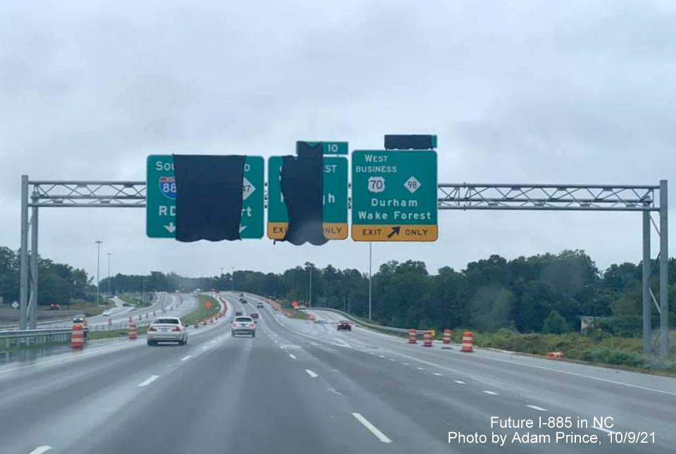 Image of overhead signs, some covered up approaching Business US 70/NC 98 exit on US 70 East (Future I-885 South) in Durham, by Adam Prince October 2021