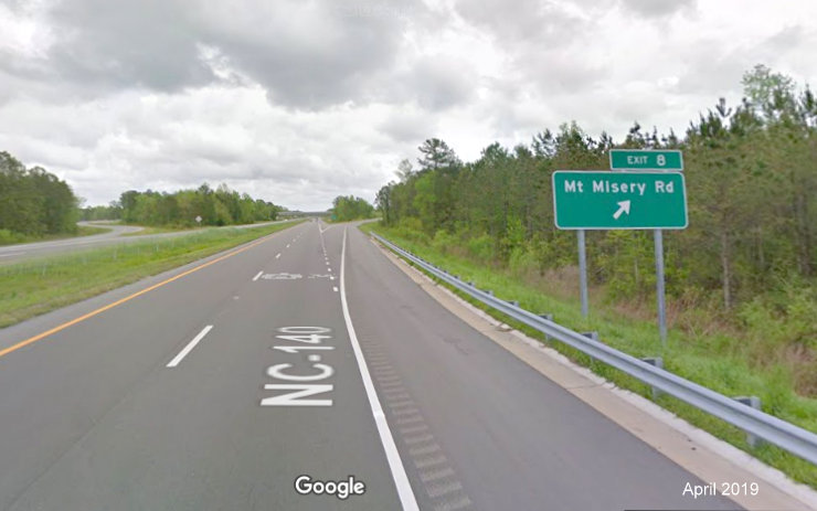 Google Maps Street View image of ground mounted exit ramp sign for Mt Misery Road in Leland, taken in April 2019
