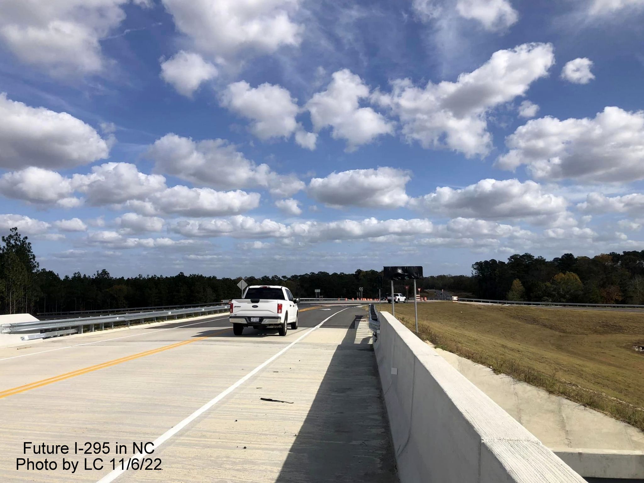 Image taken looking east along Black Bridge Road bridge toward new roundabout with ramps 
        for soon to be opened section of Fayetteville Outer Loop to Parkton/Leeper Roads, by LC, November 2022