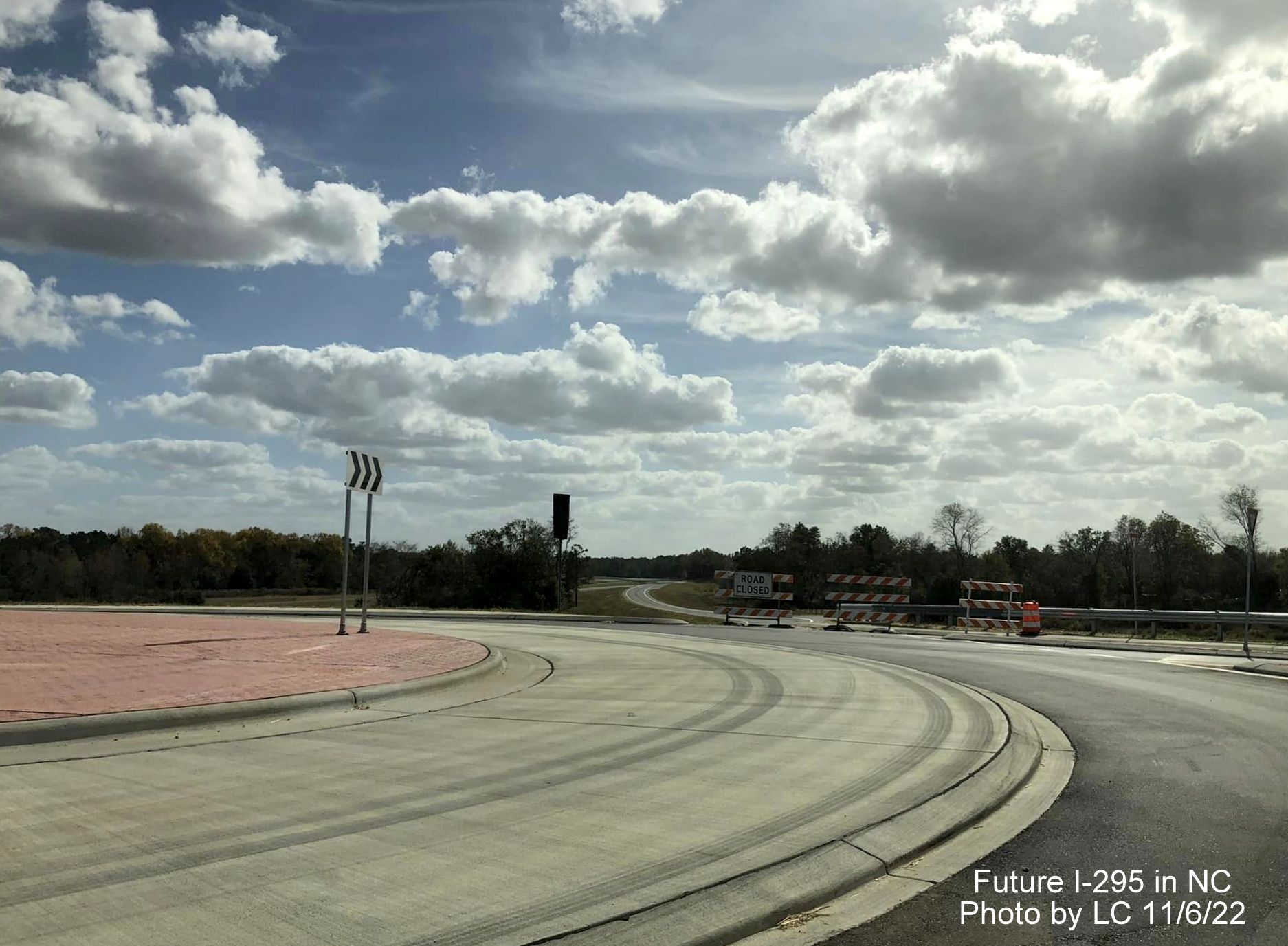 Image taken along Black Bridge Road approaching new roundabout with ramps for soon to 
        be opened section of Fayetteville Outer Loop to Parkton/Leeper Roads, by LC, November 2022