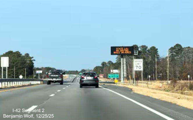 Image of Speed Limit 70 MPH sign on US 70 (Future I-42) West following the Neuse 
	River bridge, screen grab from Benjamin Wolf video, December 2025