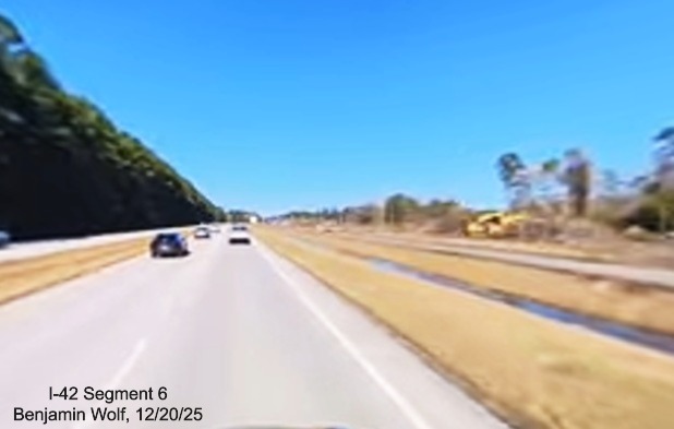 Image of construction along US 70 West approaching Camp Kiro Road,
		screen grab from Benjamin Wolf video, December 2025