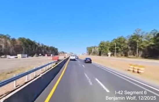 Image of new pavement along US 70 West approaching the future Taberna Way exit,
		screen grab from Benjamin Wolf video, December 2025
