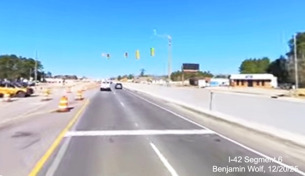 Image of traffic approaching stop light on US 70 West for turnaround for text 
		traffic from Grantham Road,	screen grab from Benjamin Wolf video, December 2025