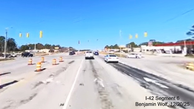 Image of traffic at the Airport Road intersection on US 70 (Future) I-42 
		West, screen grab from Benjamin Wolf video, December 2025