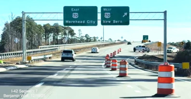 Image of new overhead signs at the end of US 70 East at the eastern end of
	the US 70 (Future I-42) Havelock Bypass, Screen grab from Benjamin Wolf video, December 2025