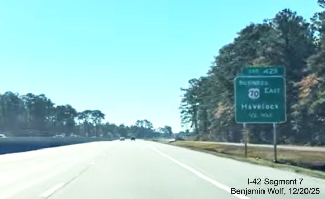 Image of 1/2 Mile advance sign for Business US 70 East exit at the west end of the US 
	70 (Future I-42) East Havelock Bypass, Screen grab from Benjamin Wolf video, December 2025