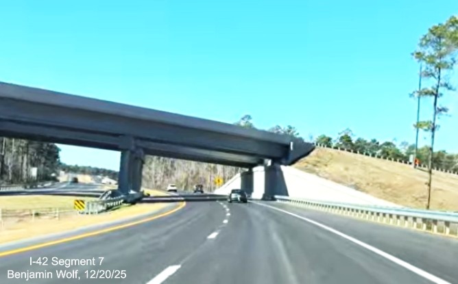 Image of West US 70 passing under the bridge carrying East Business 70 at the end
	of the US 70 (Future I-42) East Havelock Bypass, Screen grab from Benjamin Wolf video, December 2025