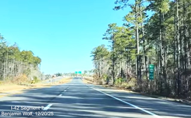 Image of ground mounted 1 mile advance sign for East Business 70 on US 70 (Future 
	I-42) West Havelock Bypass, Screen grab from Benjamin Wolf video, December 2025