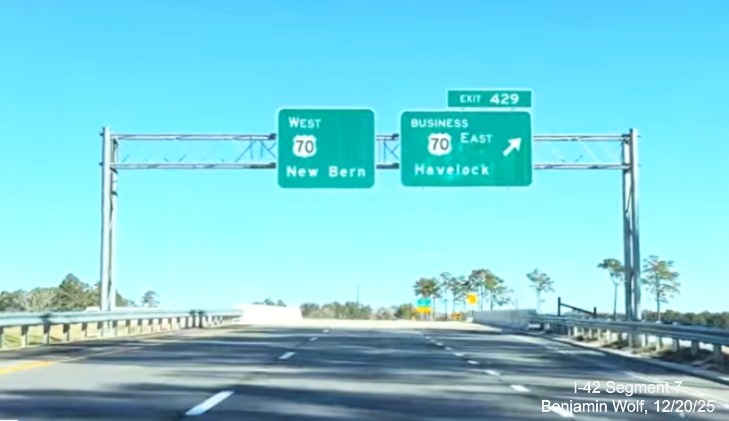 Image of overhead signage at the Business US 70 East exit at the west end of the US 
	70 (Future I-42) West Havelock Bypass, Screen grab from Benjamin Wolf video, December 2025