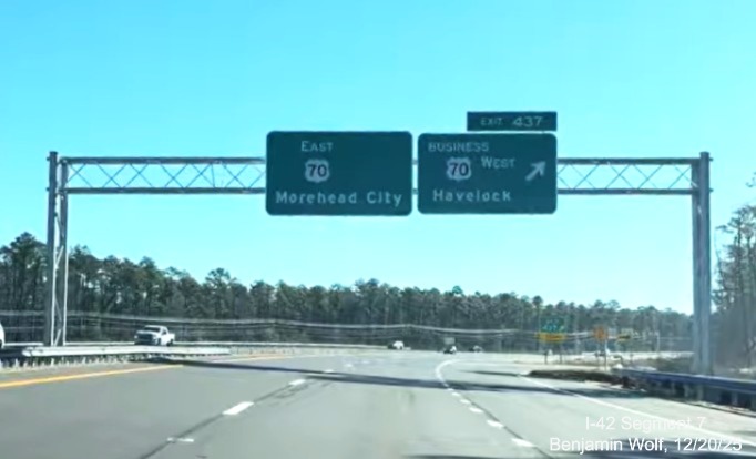 Image of overhead signage at the Business US 70 West exit at the end of the US 70 
	(Future I-42) East Havelock Bypass, Screen grab from Benjamin Wolf video, December 2025