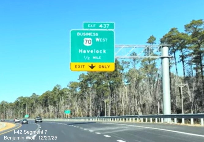 Image of 1/2 mile advance overhead sign for Business West US 70 exit prior to the 
	start of the US 70 (Future I-42) West Havelock Bypass, Screen grab from Benjamin Wolf video, December 2025