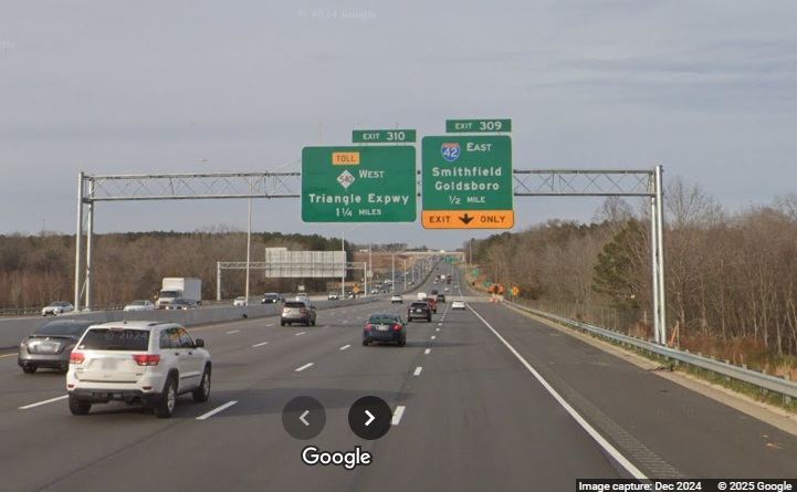 Image of newly placed overhead exit sign for I-42 East/Clayton Bypass on I-40 West 
		Google Maps Street View, December 2024