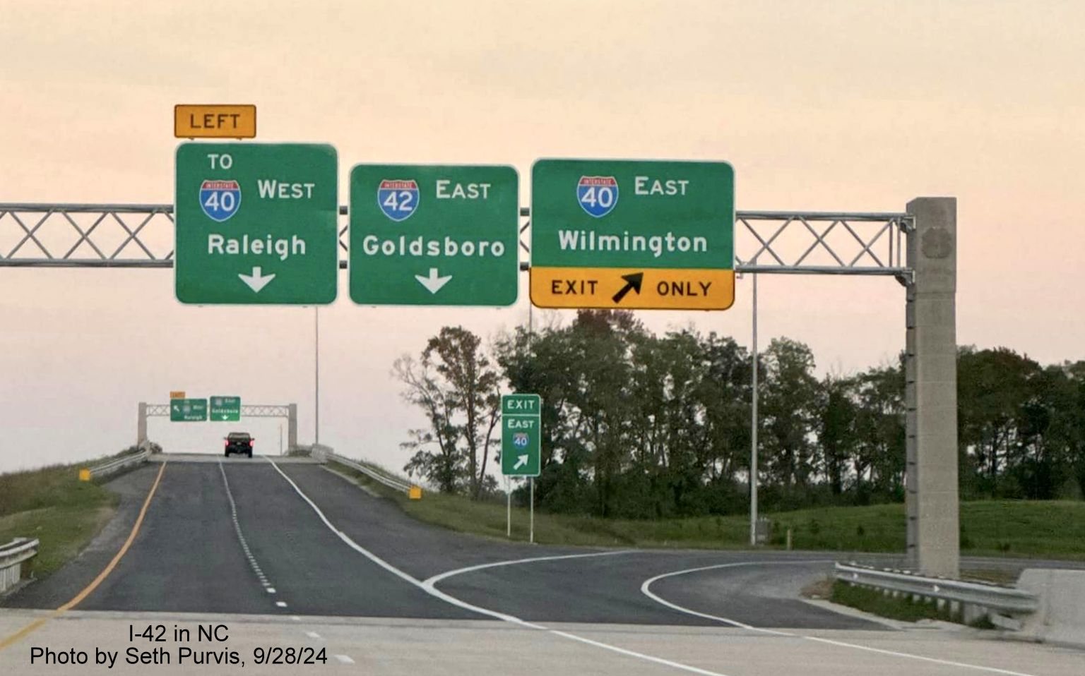 Image of overhead sign for I-40 and I-42 exits from current end of NC 540/Triangle Expressway at
the Turbine Interchange, by Seth Purvis, September 2024