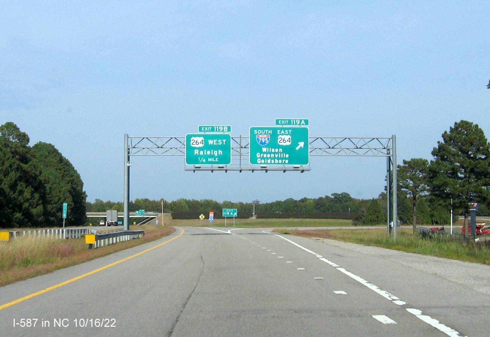 Image of overhead ramp signs for I-587/I-795/US 264 exit not updated to include I-587 shield on I-95 North 
                                       in Wilson,October 2022