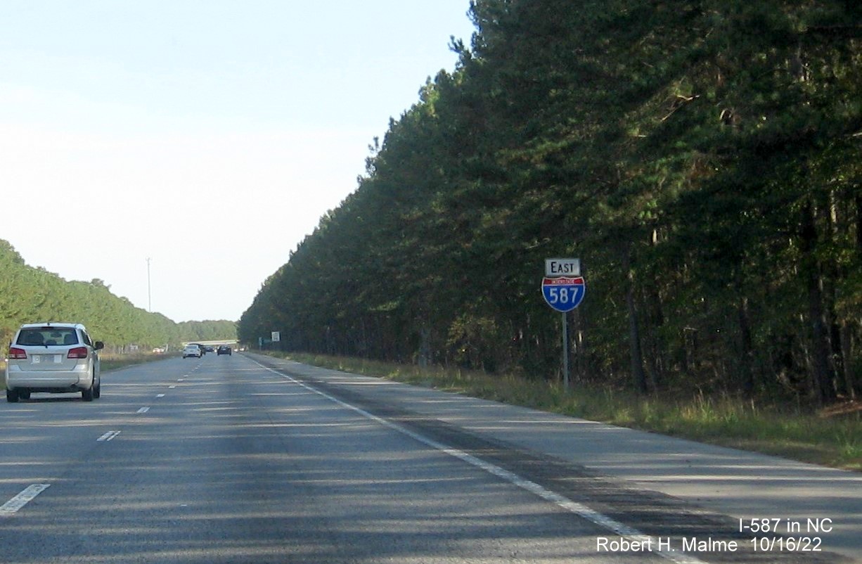 Image of 1 mile advance sign for NC 111/222 exit with new I-587 milepost exit number on I-587 East in Saratoga, October 2022