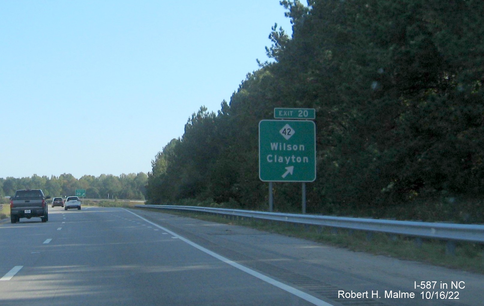 Image of ground mounted ramp sign for NC 42 exit with new I-587 milepost exit number on I-587/US 264 East,I-795 
                                        South in Wilson, October 2022