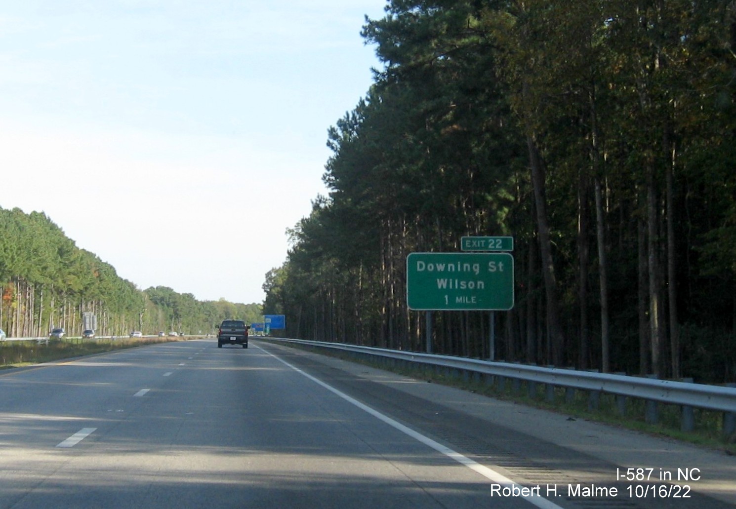 Image of 1 mile advance sign for Downing Street exit with new I-587 milepost exit number on I-587/US 264 East,I-795 
                                        South in Wilson, October 2022