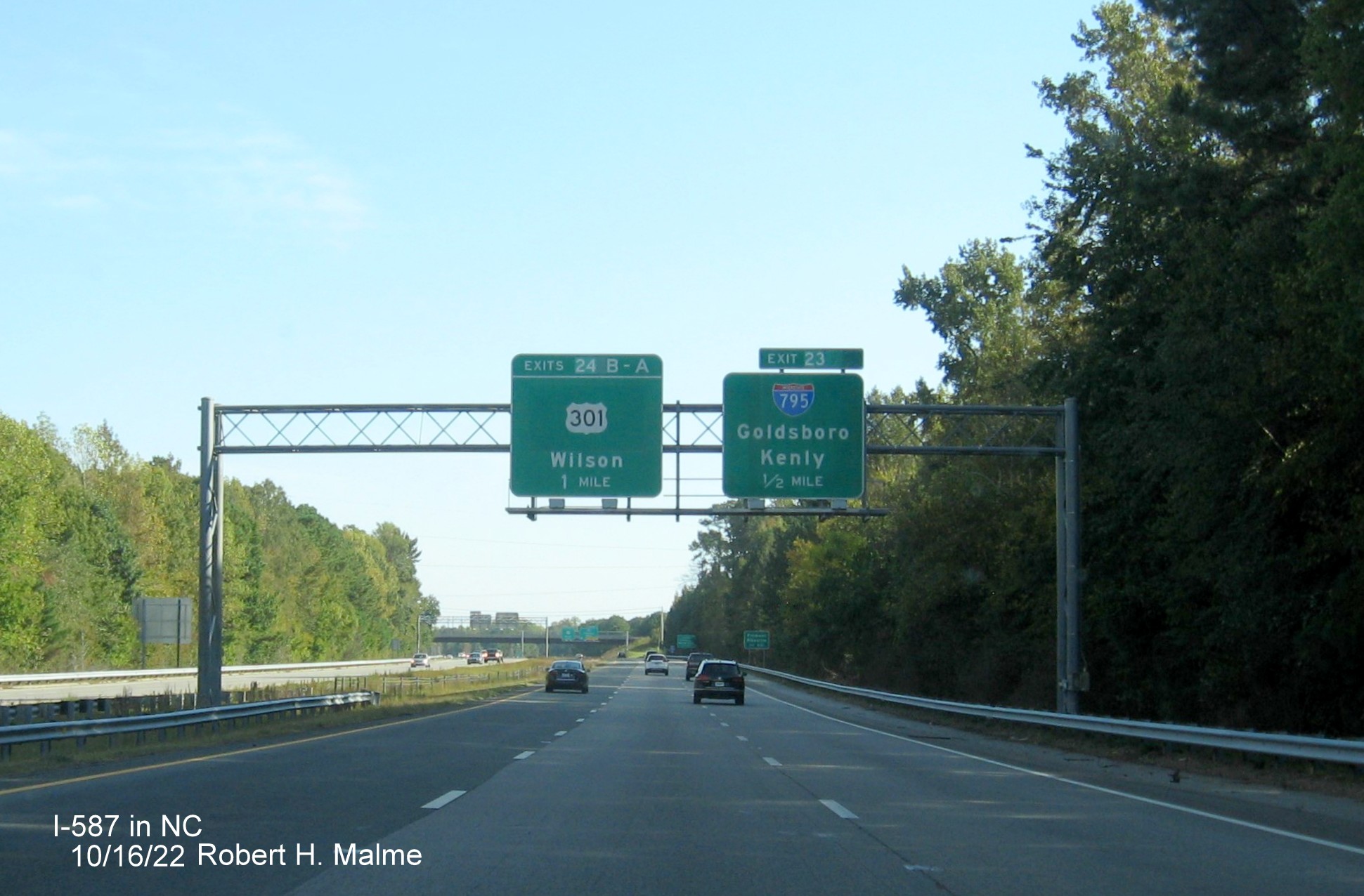 Image of 1/2 mile advance sign for NC 42 exit with new I-587 milepost exit number on I-587/US 264 East,I-795 
                                        South in Wilson, October 2022