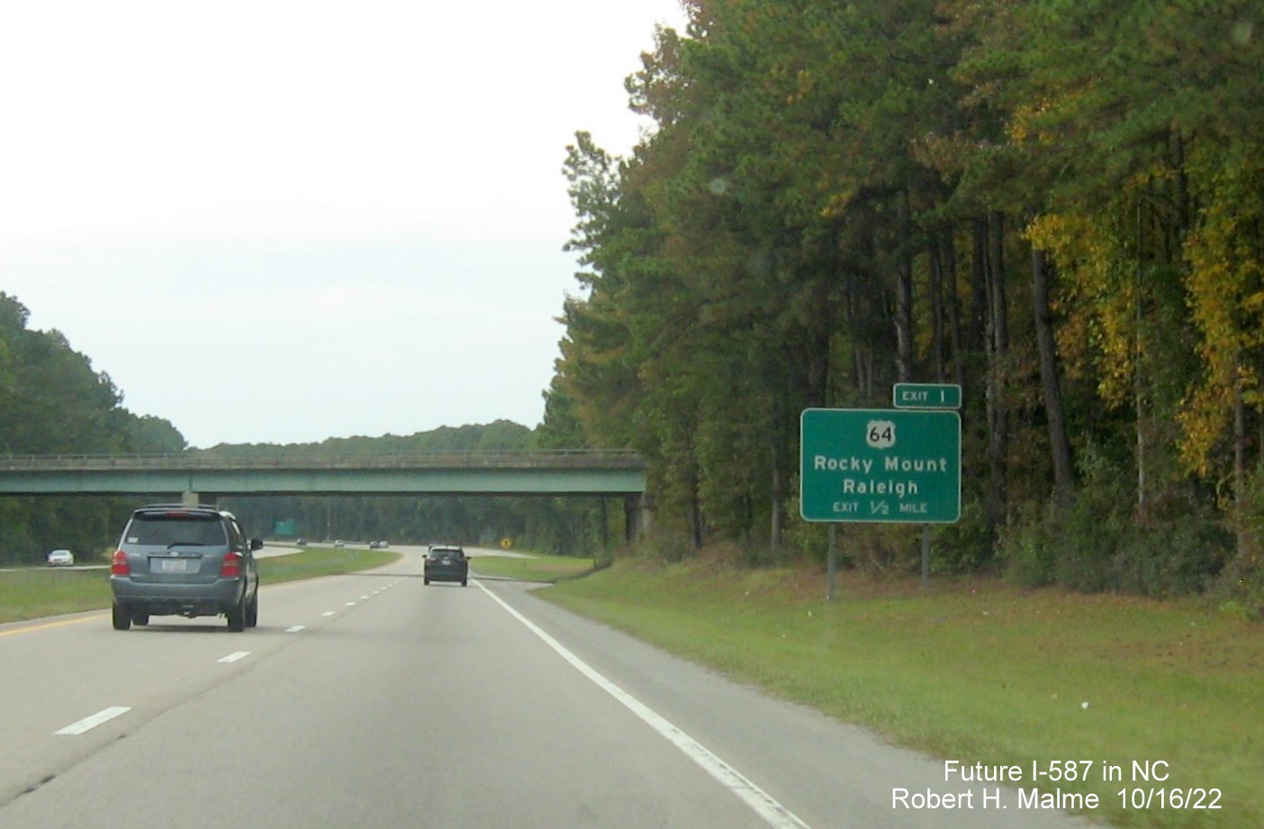 Image of ground mounted 1/2 mile advance sign for US 64 East exit with new Future I-587 mileage exit number, October 2022