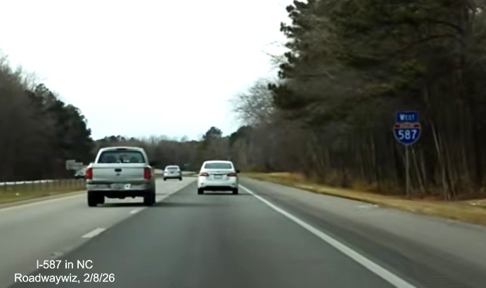 Image of West I-587 reassurance marker, now with blue direction tab, after the Mozingo Road
	exit in Greenville, screen grab from Roadwaywiz video, February 2026