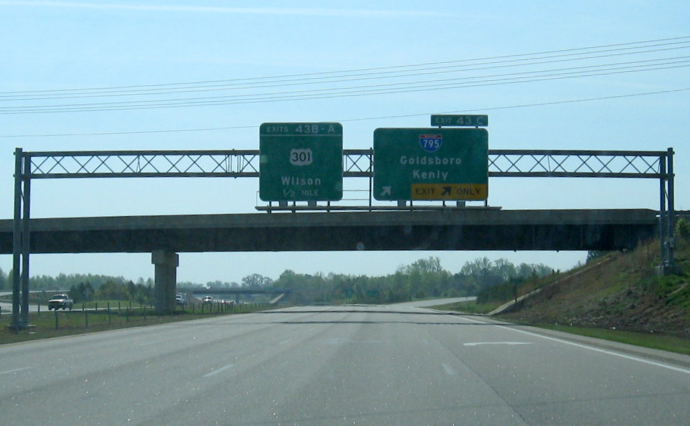 Final overhead sign for I-795 on US 264 East which replaced simple ground-mounted 
          trailblazer sign in March 2010